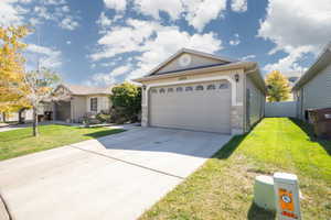 Ranch-style house featuring a front yard and a garage