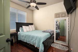 Bedroom featuring ceiling fan and dark hardwood / wood-style floors