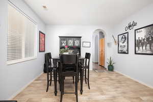 Dining area with light hardwood / wood-style flooring