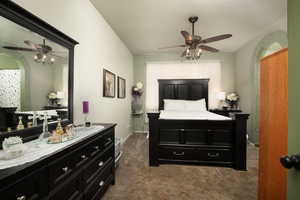 Bedroom featuring dark carpet and ceiling fan