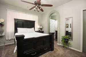 Bedroom with dark colored carpet and ceiling fan