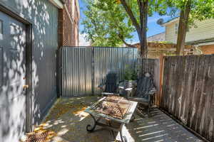 View of patio with an outdoor fire pit