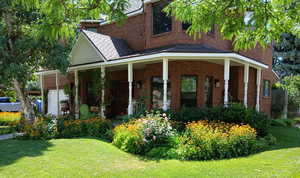 Exterior space featuring a porch and a lawn