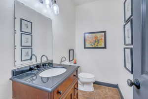 Bathroom with tile patterned flooring, vanity, and toilet