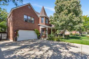 View of front of property with a garage and a front lawn