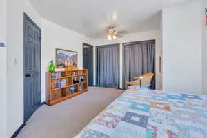 Carpeted bedroom with ceiling fan