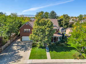 View of front of house with a mountain view, a front yard, and a garage