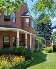 View of side of property with a lawn