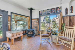 Sunroom featuring a wood stove