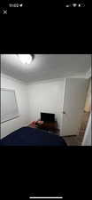 Carpeted bedroom featuring ornamental molding