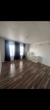 Spare room with a textured ceiling and dark wood-type flooring