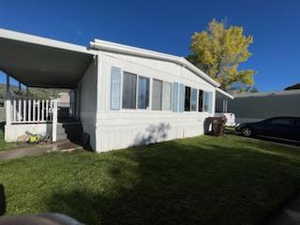 View of side of property with a yard