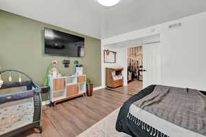 Bedroom with light hardwood / wood-style floors