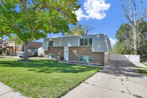 Bi-level home featuring a front lawn