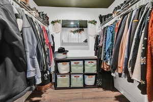 Spacious closet featuring light hardwood / wood-style floors