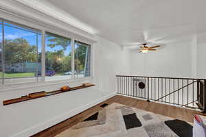 Spare room featuring wood-type flooring and ceiling fan