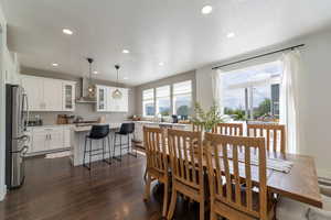 Dining space with a textured ceiling, sink, and dark hardwood / wood-style flooring