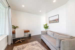 Office area featuring plenty of natural light and dark hardwood / wood-style flooring