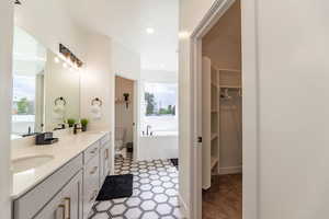 Bathroom with a bathing tub, toilet, and vanity