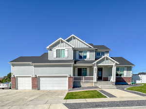 Craftsman house featuring a garage and covered porch