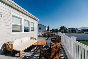 Deck with outdoor lounge area and a mountain view