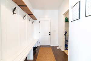 Mudroom with dark hardwood / wood-style flooring