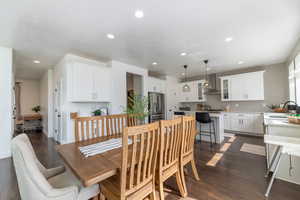 Dining area with a textured ceiling, dark hardwood / wood-style floors, and sink