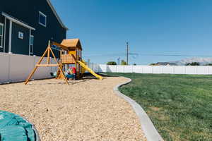 View of jungle gym with a yard