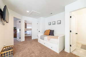 Sitting room featuring light carpet and a textured ceiling