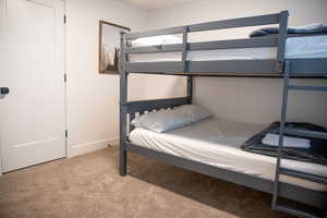 Bedroom featuring light colored carpet