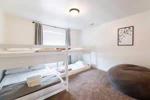 Bedroom featuring a textured ceiling and carpet flooring