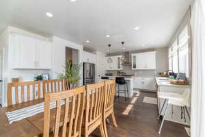 Dining room with sink, dark hardwood / wood-style flooring, and a textured ceiling