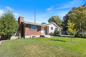 Ranch-style house with a front lawn