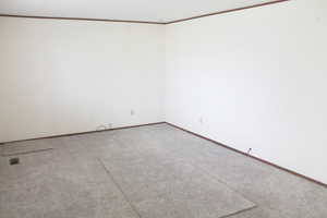 Carpeted empty room featuring baseboards