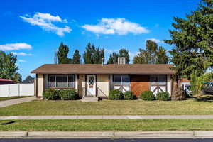 Single story home with a front yard