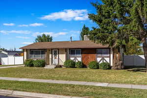 Ranch-style home featuring fence and a front yard