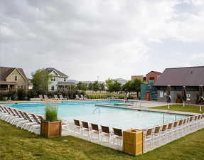 View of pool featuring a yard and a patio