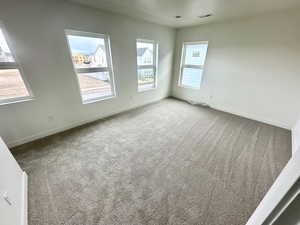 Spare room featuring carpet