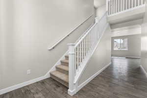 Staircase featuring hardwood / wood-style floors