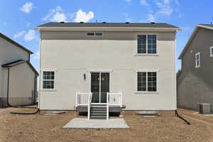 Rear view of house with central air condition unit