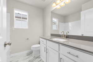 Bathroom featuring vanity and toilet