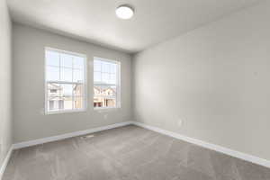 Empty room featuring carpet floors and a textured ceiling