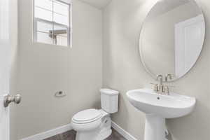 Bathroom with hardwood / wood-style floors and toilet