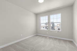 Spare room with a textured ceiling and carpet floors