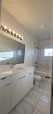 Full bathroom featuring vanity, toilet, and tiled shower / bath