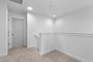 Spacious closet with light colored carpet