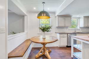 Kitchen with decorative backsplash, dishwasher, wooden counters, dark hardwood / wood-style floors, and sink