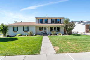 View of front of home with a front yard and a porch