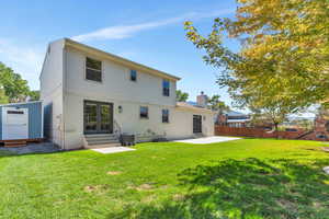 Back of house featuring a patio and a yard