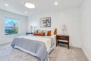 Carpeted bedroom with wood walls